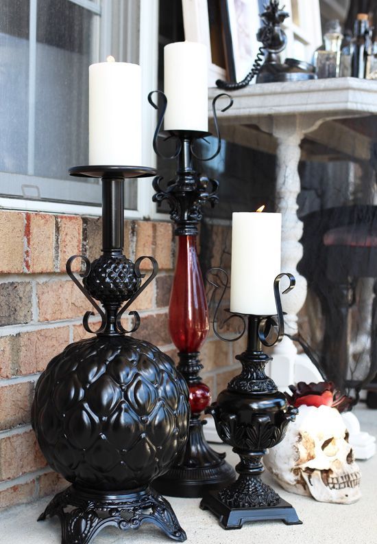 turn thriftstore lamps into Halloween candleholders and paint them black to make the decor more refined and elegant