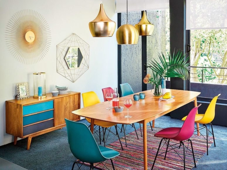 a bright mid-century modenr dining space done with various shades of red, ble and metallics for a shiny touch