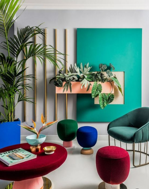 A bold living room done in emerald, forest green, cobalt blue and deep red   jewel tones never go out of style