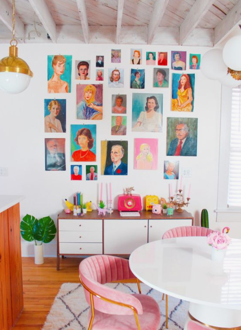 a colorful space done in orange and pink, with a bright and colorful gallery wall, which adds a whimsy touch to the space