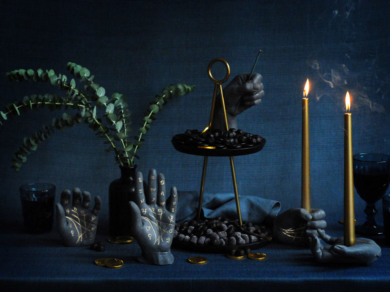 black palmistry Halloween candleholders and decorations with gold runes look bold and contrasting