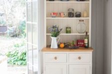 22 a small and cozy white buffet in the corner of your kitchen will give a nice farmhouse touch to the space
