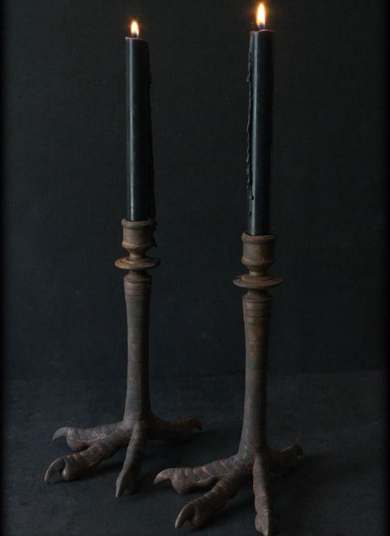 rusted antique bird claw candle sticks with black candles are a gorgeous and non-traditional idea to try