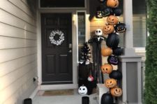 Nightmare Before Christmas porch with carved black and orange pumpkins, Jack Skellington and candle lanterns