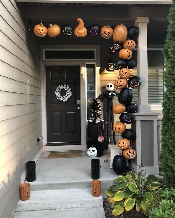 Nightmare Before Christmas porch with carved black and orange pumpkins, Jack Skellington and candle lanterns