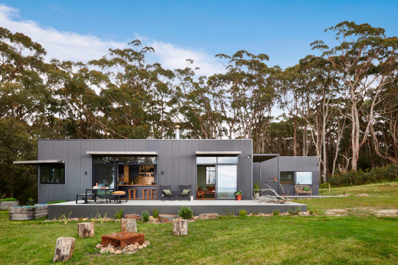 This modern home was built in Australia and clad with grey corrugated steel siding to give it a fresh modern look