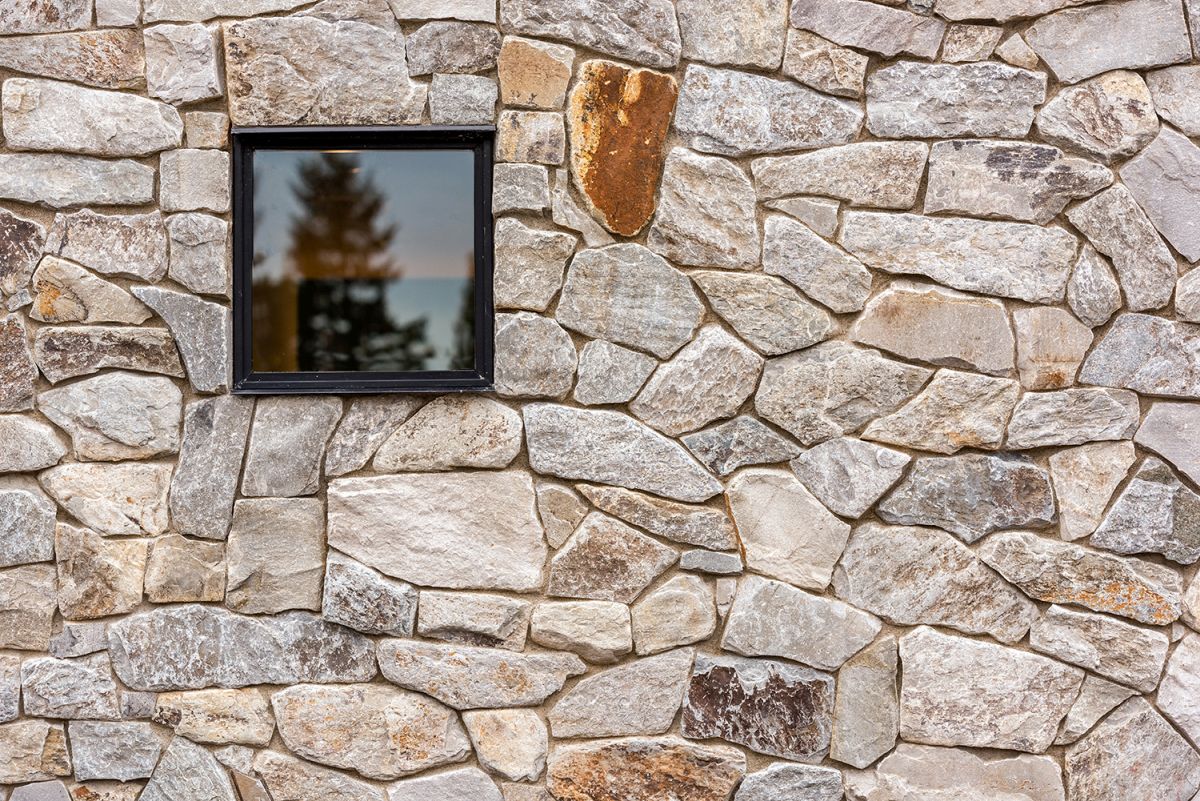 The house is clad with locally sourced wood and stone, which help it blend with the surroundings