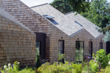 03 The house is fully clad with shingles and it looks like a fresh take on a traditional barn, with sculptural shapes