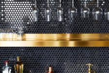 03 a black penny tile backsplash and gold shelves and fixtures make up a very chic and refined combo