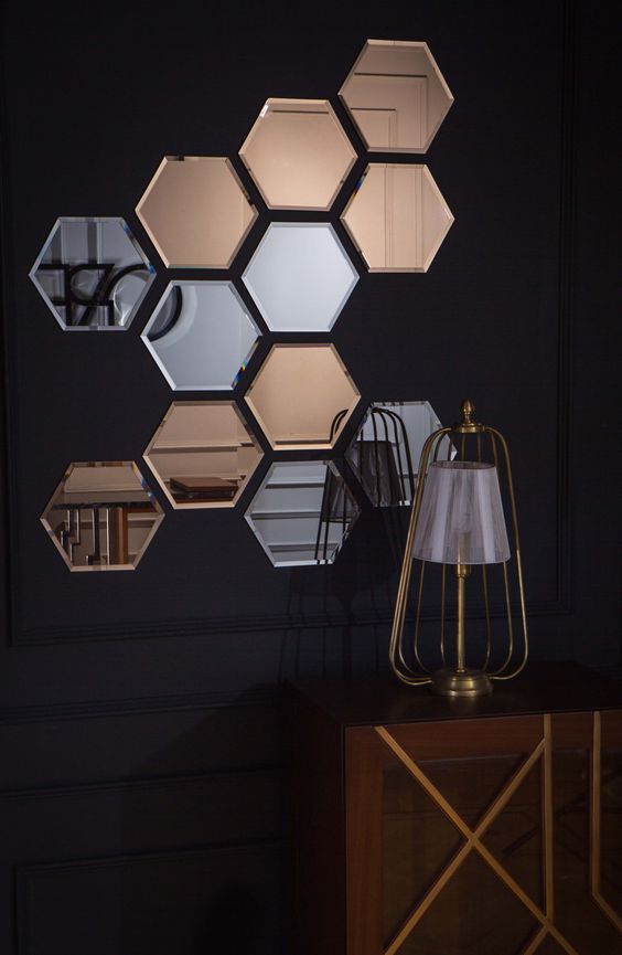 an arrangement of silver and copper hexagon mirrors will make any blank wall stand out