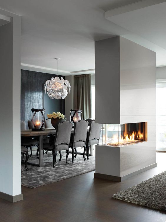 A sleek white minimalist double sided fireplace will give a chic look to the space and make it cozy