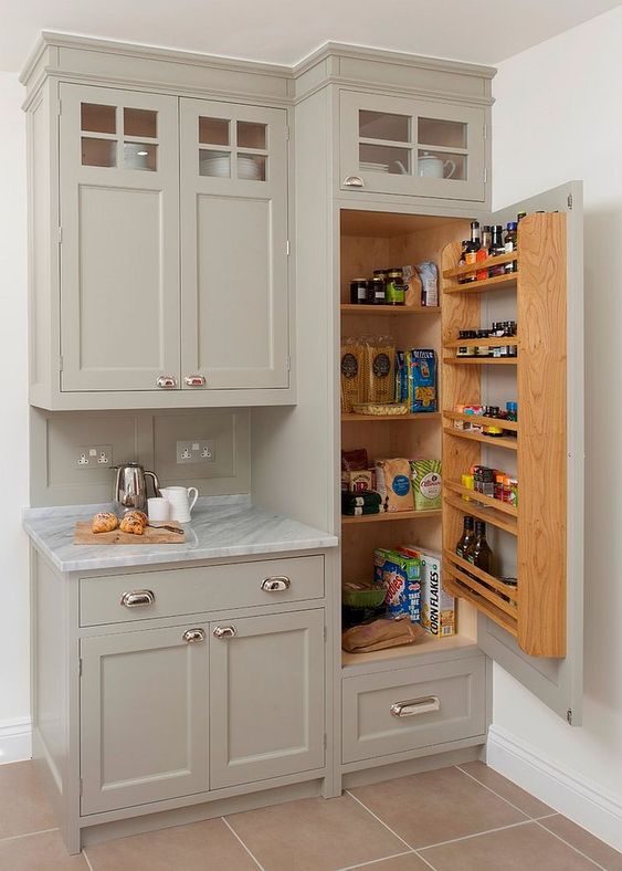 a small built-in pantry with some shelves inside and on the door is a cool idea for a tiny kitchen