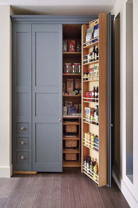 a built-in pantry with lots of basket drawers, shelves on the doors and inside is a cool idea to use an awkward nook
