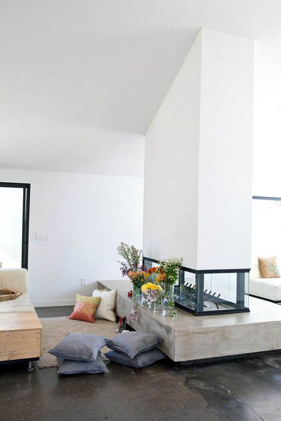 A stylish white double sided fireplace with a glass part and a concrete one is a chic idea for a contemporary home