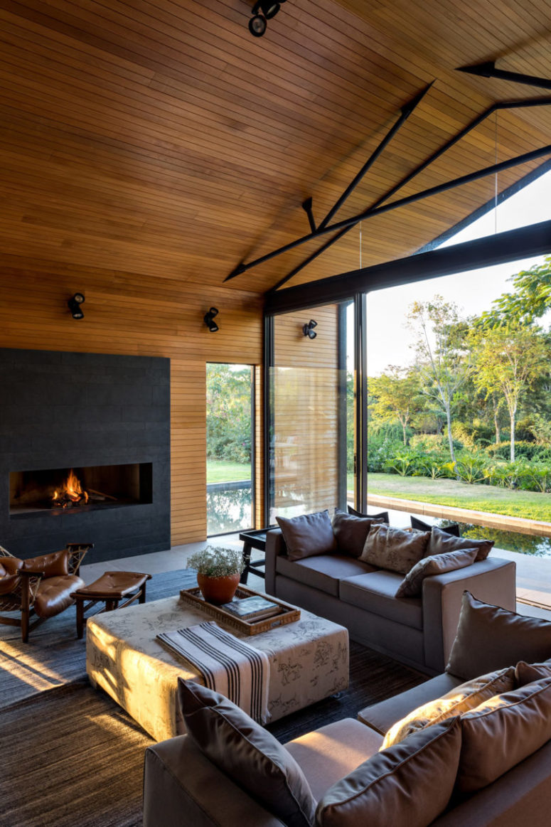 An indoor-outdoor space is done with comfortable furniture and there's a modenr fireplace to create an ambience