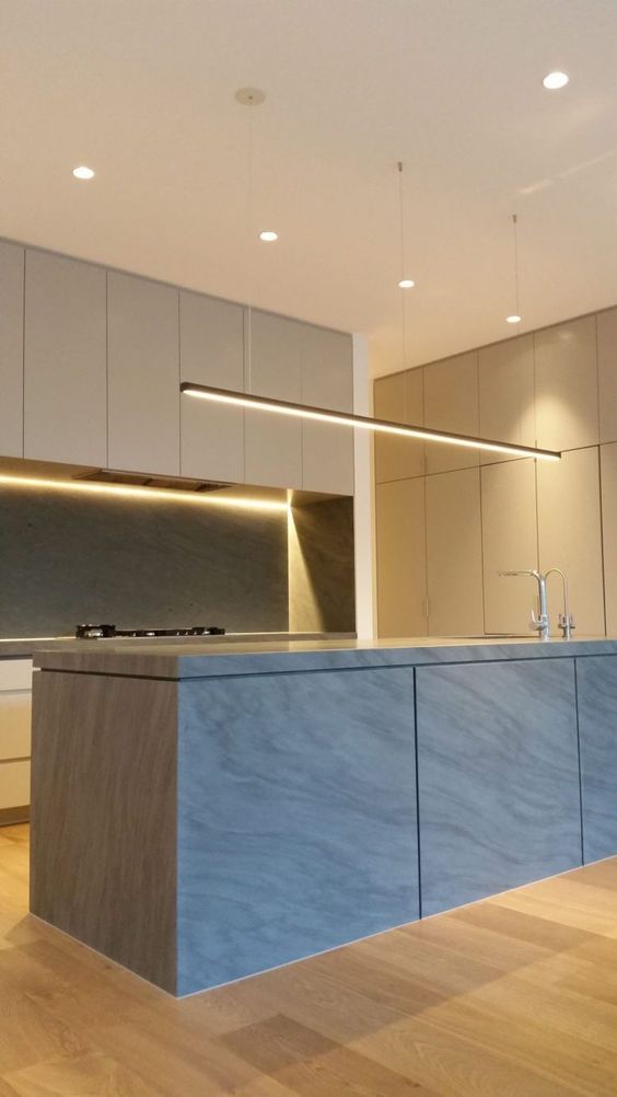 a minimalist kitchen with sleek cabinets and lots of built-in lights looks very chic and very edgy