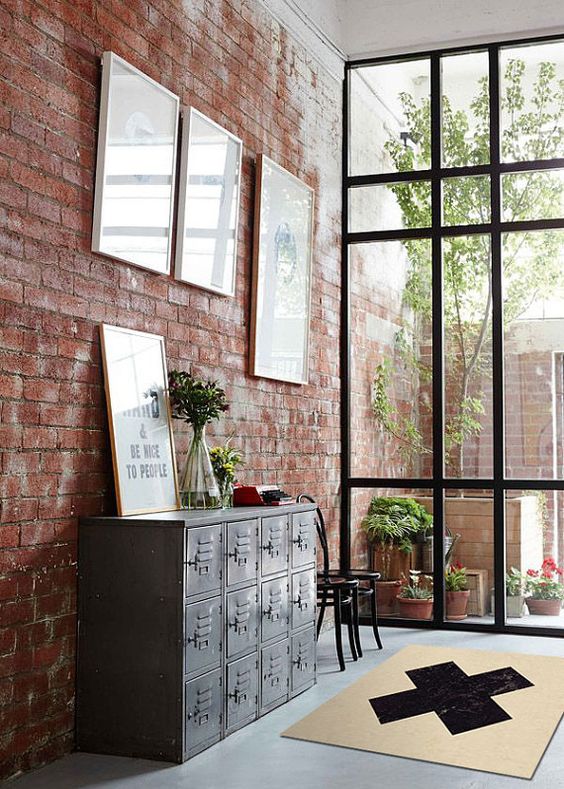 a red brick wall and a vintage metal cainet make the spac industrial and give it a vintage feel at the same time