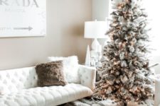 07 a snowy Christmas tree with pinecones and lights and some white branches on top, candles and fluffy pillows