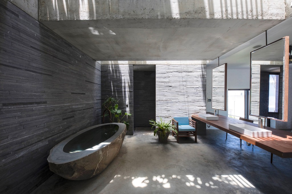 There's also an indoor outdoor bathroom with a carved stone tub and a large floating vanity with mirrors