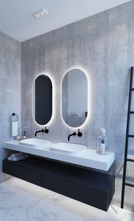 a minimalist bathroom highlighted with backlighting behind the mirrors looks bolder and brighter