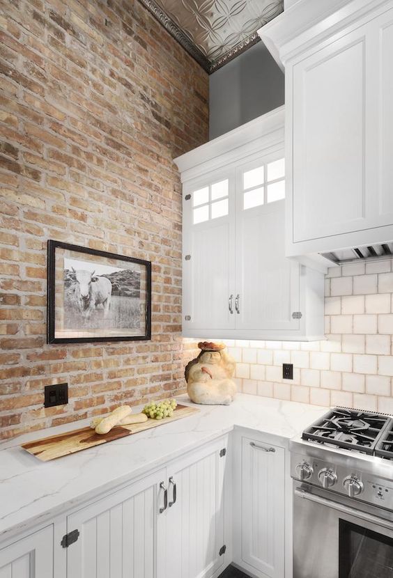 a neutral brick wall will give less color to the space but not less texture, so it's a cool idea
