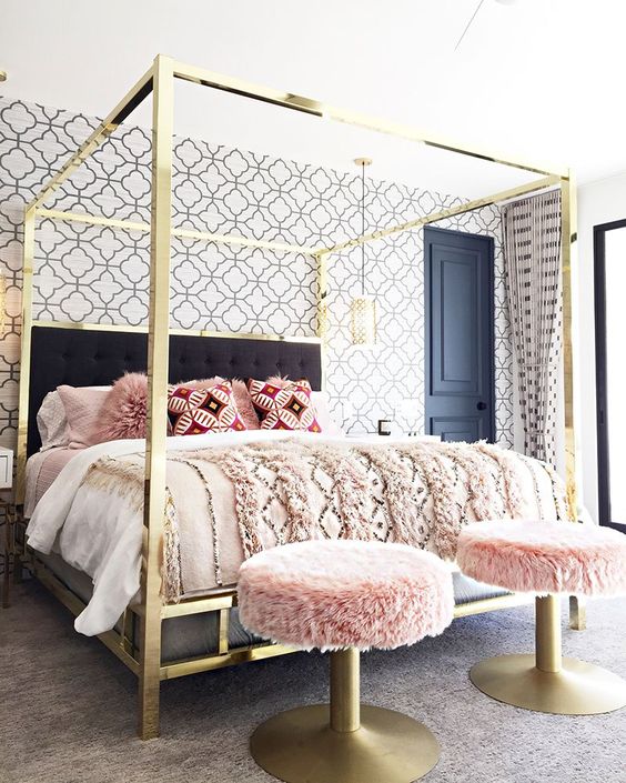 a super glam and shiny gold canopy bed will add a sparkly and chic touch to the bedroom, and brass stools continue the decor theme