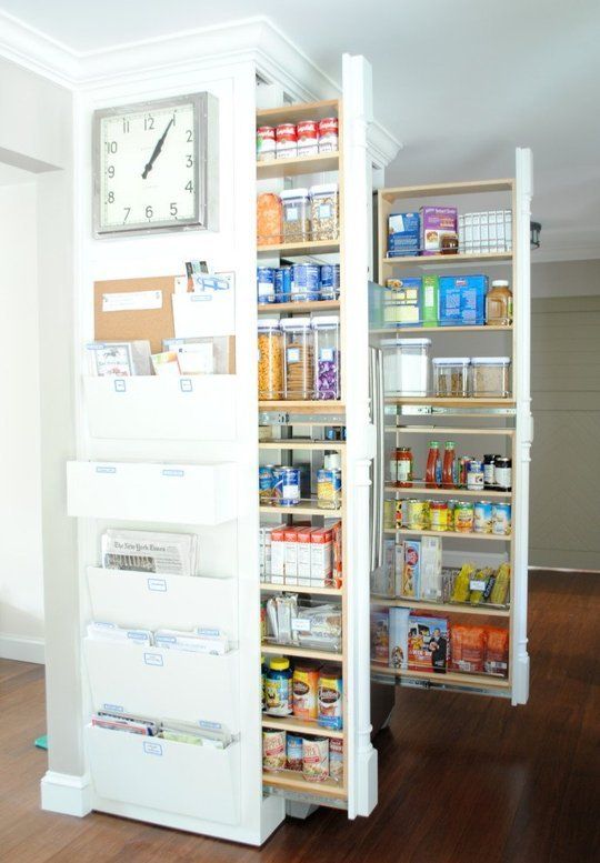 A mini built in pantry with rolling out shelving units   here you can store lots of things easily