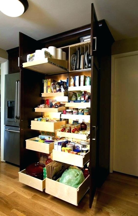 A dark built in pantry with pull out shelves and drawers and additional lights help you find everything