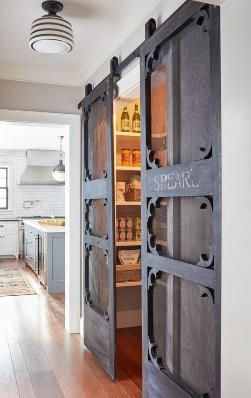 A pantry with whimsy barn inspired sliding doors, which are a cool idea to save some space