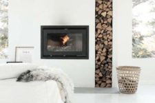 13 a minimalist built-in fireplace with a tall and narrow firewood storage space looks very edgy