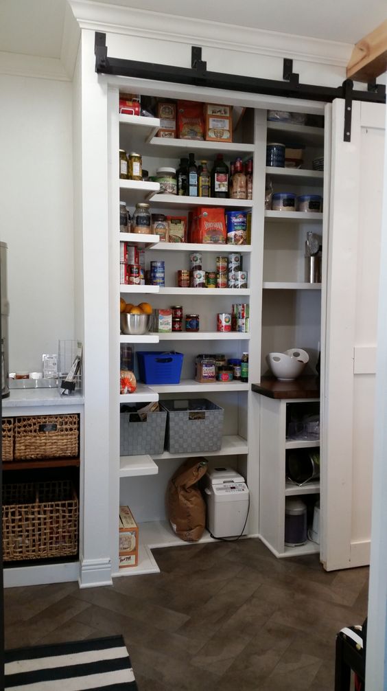 a cool small yet functional built-in pantry with sliding doors that allow opening it easily and fast