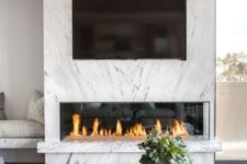 15 a minimalist fireplace enclosed into marble looks refined, chic and gorgeous and gives an edgy feel to the space