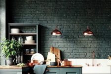 16 a black brick backsplash matches the forest green cabinets and wooden countertops creating a moody feel in the space