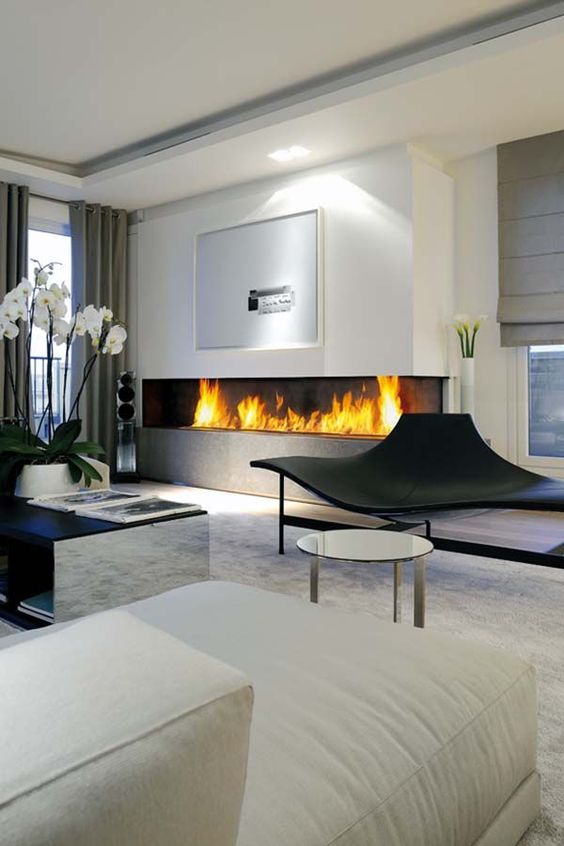 a large minimalist built-in fireplace in the living room is a stylish and bold idea with a modern feel