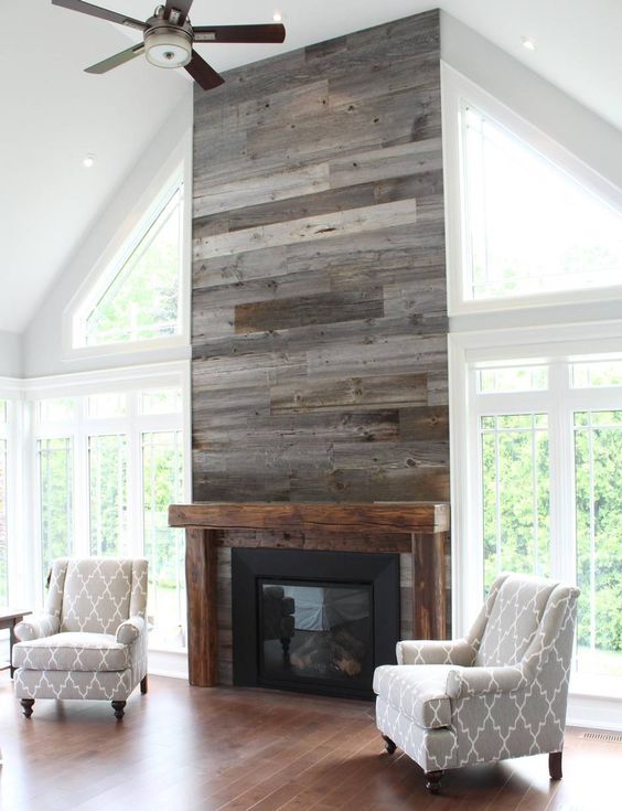 a grey reclaimed wood wall with a built-in fireplace is a warming up idea for a living room