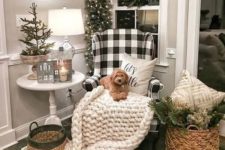 17 a neutral nook with a chunky knit blanket, evergreens and a Christmas tree with lights, baskets and berries plus a buffalo check chair