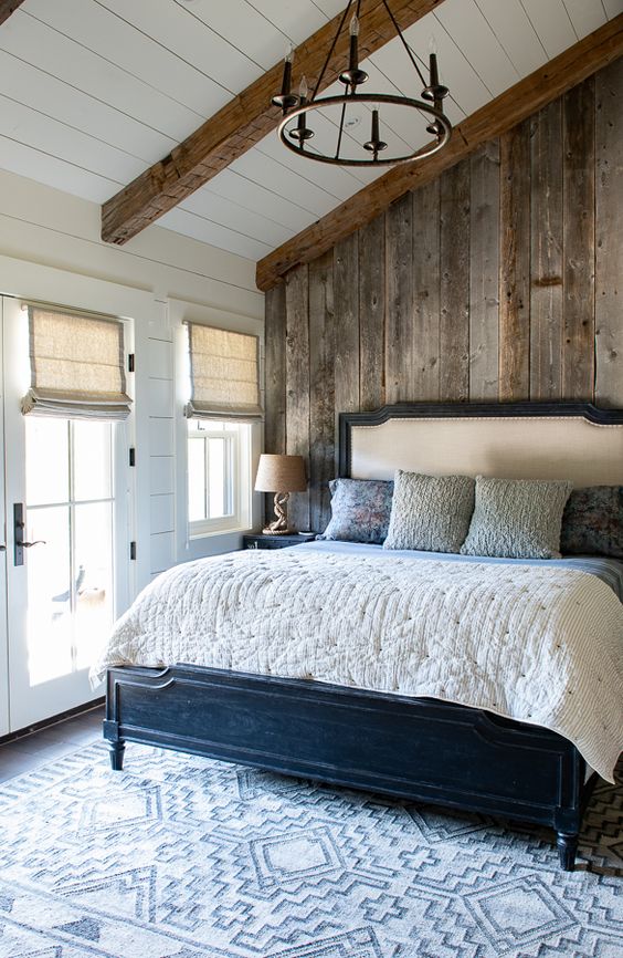 a relaimed wooden wall and matching wooden beams make the space very cozy and warm
