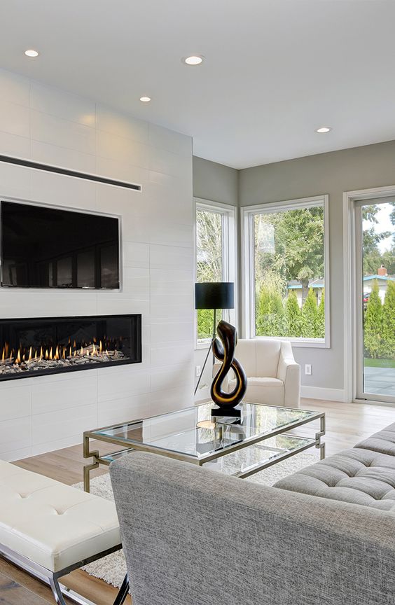 a white built-in minimalist fireplace under the TV is a stylish and elegant idea that adds coziness
