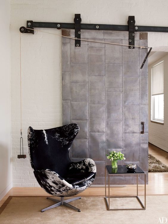 a sliding metal door will add a strong industrial feel to your space making it bolder