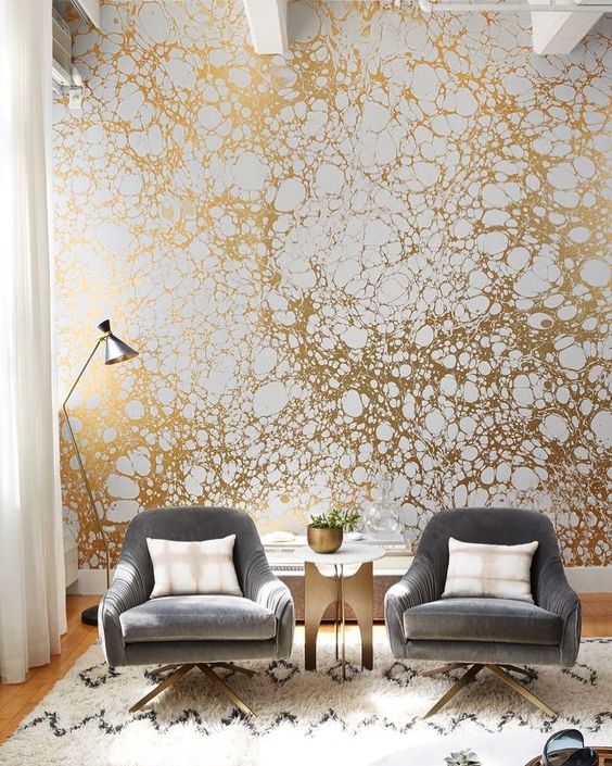 a printed gold and white wallpaper wall will make your living room very bold and stylish