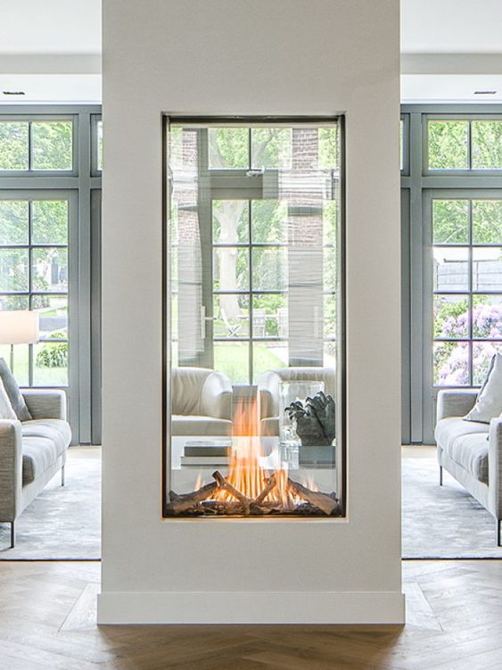A large glass encased double sided fireplace is a statement piece for any space
