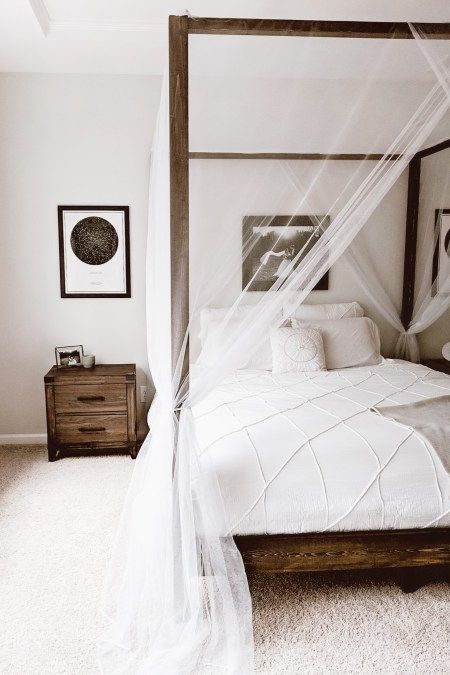 sheer and airy white curtains add a decorative effect to the space without separating the bed from the rest of the space