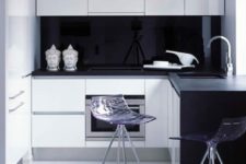 24 a tiny black and white minimalist kitchen with a sleek black glass backsplash that makes the contrast stronger