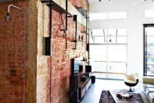 25 a brick wall and exposed black pipes make the space feel industrial and add interest to it