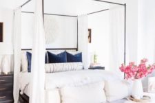 25 style your canopy bed with simple flowy white curtains for some privacy and to make the space cozier