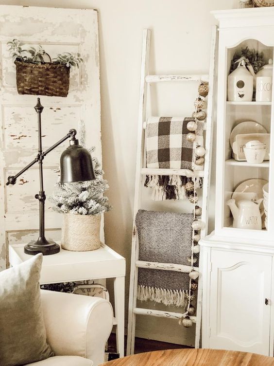 a white ladder with blankets and lights will easily fill in an awkward book giving you storage space