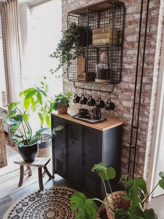 a black metal cabinet with a wooden top that softens it and a shelving unit on the wall for an industrial feel