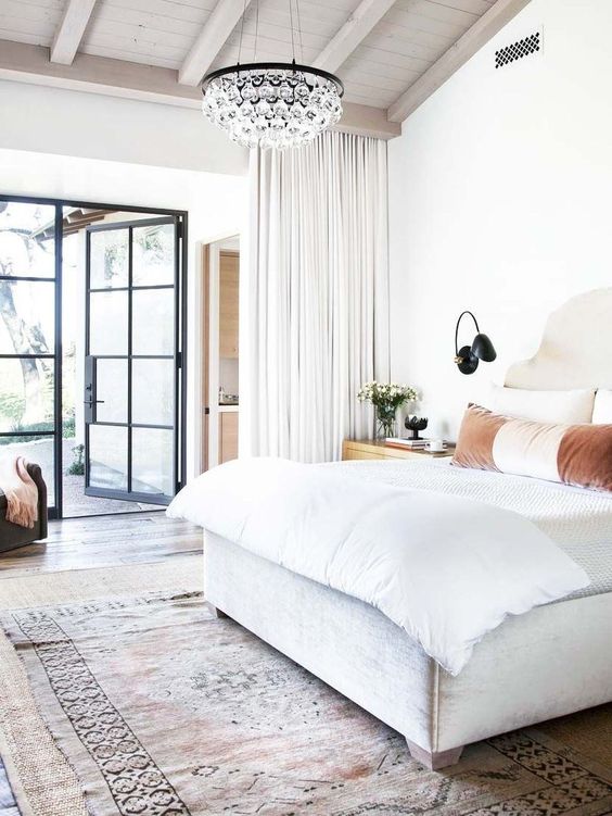 a fresh and modern bedroom with a small crystal chandelier for an elegant touch