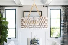 31 a dining space spruced up with a designer chandelier on gold chains for a sparkly touch