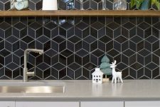 a chic off-white kitchen with grey countertops and glossy black geometric tiles on the backsplash is amazing